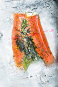 Vacuum packed char fillets with herbs in water