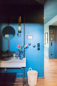 Washstand with twin sinks against blue wall in hall