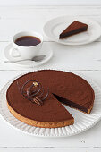 Chocolate torte with an elegant tuile served with a coffee