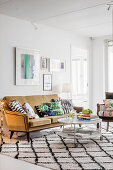 Ochre-yellow sofa and diamond-patterned rug in living room