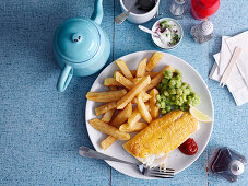 Fried fish with chips and mushy peas