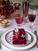 Christmas table setting with napkin and wine glasses