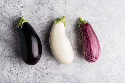 Three different coloured aubergines