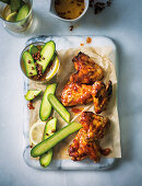 Sticky chicken wings with peppery cucumber pickle