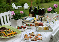 A festively laid buffet table in a summery garden