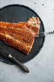 Smoked salmon with pepper on black stone