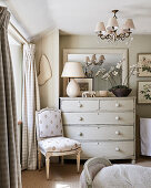 Antique chair next to chest of drawers in bedroom