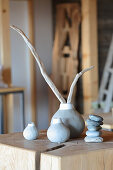 Pieces of driftwood in simple white-and-grey vases