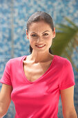A young brunette woman wearing a pink top