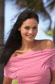 A young brunette woman wearing a red-and-white striped top