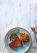 Sweet and sticky t-bone steak with blooming onions