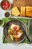 Cornbread with poached eggs, cherry tomatoes and avocado