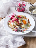 Buckwheat pancakes with red cabbage sauerkraut and fried egg