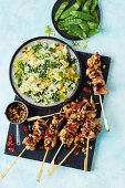 Chicken and cashew nut skewers with egg fried rice