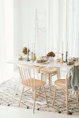 Table set for autumn dinner in bright interior