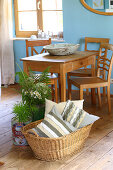 Scatter cushions with DIY covers made from strips of fabric in basket