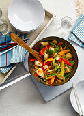 Fiery chicken with vegetables cooked in a wok