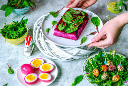 Easter terrine with beetroot and goat cheese, chicken eggs, painted beet juice, quail eggs