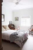 Glance into the bedroom with double bed and antique secretary