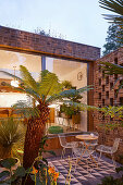 Outdoor furniture on tiled terrace at twilight