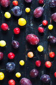 Various stone fruit on a dark wooden surface
