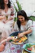 Girlfriends celebrating outdoors with Moroccan dishes
