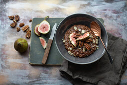 Porridge with cocoa, figs, almonds, maple syrup and pecan nuts