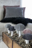 Handcrafted fabric mushrooms with velvet caps in wooden box