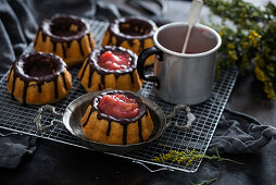 Small vegan vanilla gugelhupfs with dark chocolate, filled with strawberry and rhubarb compote