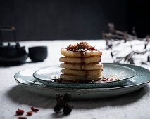 Vegan pancakes with blueberry syrup, walnuts and goji berries