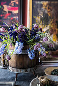 Spring flowers in wooden tub on desk