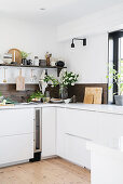 Dark wooden splashback in white kitchen