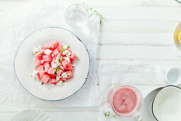 Fresh summer watermelon salad with feta cheese and greens