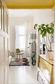 Light-flooded bedroom in white and yellow