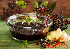 Homemade spicy elderberry compote with fresh ginger and chili