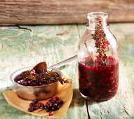 Homemade elderberry herbal syrup with fresh sage and thyme