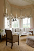 Sofa in seating area in bay window of period villa