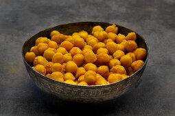 A bowl of chickpeas roasted in turmeric as a healthy snack