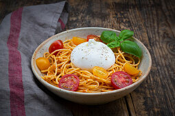 Spaghetti with pesto rosso, cherry tomatoes and burrata