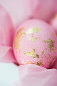 Pink eggs with gold leaf on tissue paper