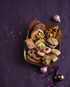 Various Christmas biscuits in a gold dish