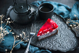 Vegan cake with a chocolate base, poppy seeds, raspberries and jelly