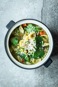Vegetable soup with orecchiette pasta and grated cheese