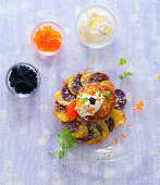 Pollack meatballs on a purple potato gratin with sour cream and trout caviar