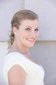 A blonde woman wearing a white shirt