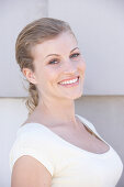 A blonde woman wearing a white shirt