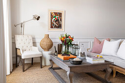 Wooden coffee table, armchair and sofa in living room