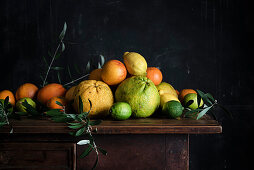 Various citrus fruits on a wooden table