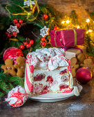 Festive christmas cake with sour cream mousse and strawberry filled profitroles