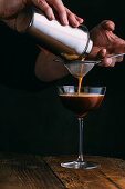 Espresso martini cocktail on dark wooden background